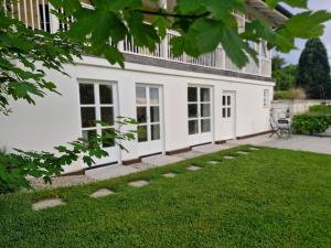 a white house with a lawn in front of it at The Garden Studio in Sankt Ruprecht an der Raab