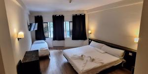 Postel nebo postele na pokoji v ubytování Hotel Garden