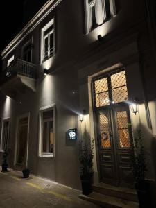 a building with a door and a window at night at Apiro Syros in Ermoupoli