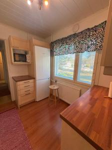 a kitchen with a table and a window in a room at Villa Tyynelä in Sodankylä