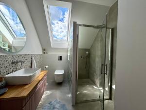 a bathroom with a glass shower and a sink at Domek na Rybackiej in Swarzewo +21 photos
