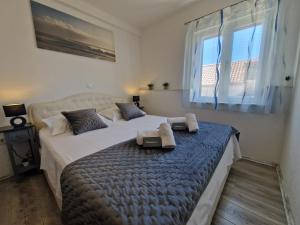 Postel nebo postele na pokoji v ubytování Apartments MB