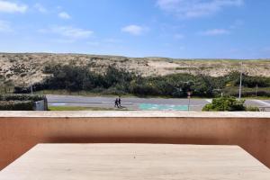 a person is riding a bike on a road at Les Semis in Soorts-Hossegor