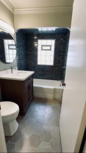 a bathroom with a toilet and a tub and a sink at Oak Park Oasis Near Chicago in Oak Park