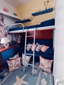 a bedroom with two bunk beds with pillows at Luxury Sea View Apartment 100 mt Mare in Costa Paradiso