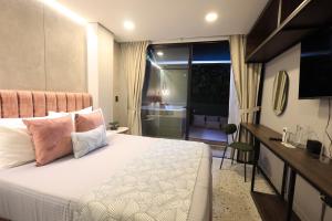 Ένα ή περισσότερα κρεβάτια σε δωμάτιο στο The O by Seekers Medellín +73 φωτογραφίες