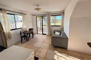 a living room with a couch and a table at Aldeias Guajiru Apart in Trairi