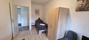 a small room with a bed and a cabinet at Monteurwohnung in Arzberg +7 photos