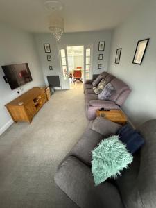 a living room with a couch and a tv at Spacious 3 bed house garden & parking sleeps 5 in Belvedere