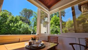 a dining room with a table and a large window at Lalovina Apartment in Herceg-Novi