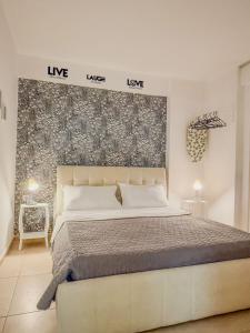 a bedroom with a large bed in a room at ODORE DI MARE APARTMENTs in Sarandë