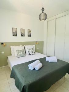 a bedroom with a bed with two pillows on it at Fiori di Luna in Porto-Vecchio