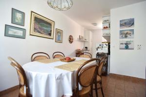 a dining room with a white table and chairs at OLD TOWN 5 apartment in Budva