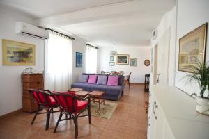 a living room with a couch and a table and chairs at OLD TOWN 5 apartment in Budva