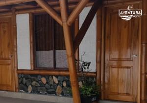 an entrance to a building with a wooden door at Hostal Aventura in Quito