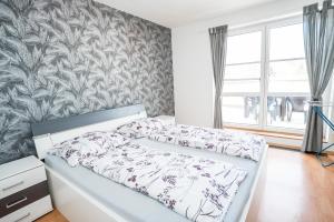 a bedroom with a bed with a floral wallpaper at Apartmá Kateřina Velké Losiny in Velké Losiny