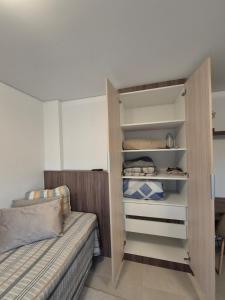 a small bedroom with a bed and a bunk bed at Studio Novo e completo perto da PUC in Curitiba
