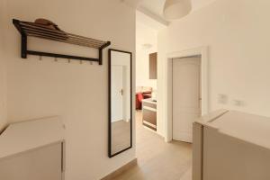 a mirror on the wall of a white room at Apartment SeaView in Utjeha