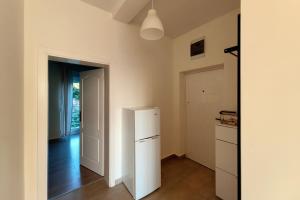 a kitchen with a white refrigerator and a door at Apartment SeaView in Utjeha