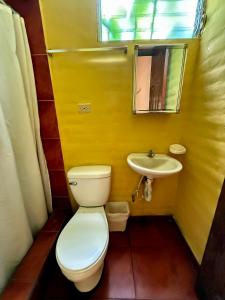 a bathroom with a toilet and a sink at Hotel Casa Miramar in Tamanique +37 photos