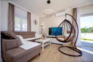 a living room with a couch and a swing at Villa Aurora in Gorovići