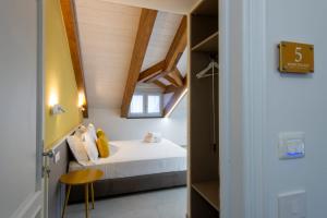 a small bedroom with a bed and a window at Rossy Palace - Amalficoast Suites in Agerola +41 photos