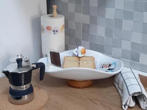 a kitchen counter with a sink with sandwiches and a coffee maker at La Casetta al Poggio in Valentano +23 photos