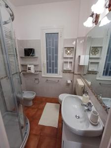 a bathroom with a sink and a shower and a toilet at Casa Sirio -Rapallo in Rapallo +8 photos