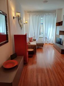 a living room with a couch and a tv at Casa Sirio -Rapallo in Rapallo