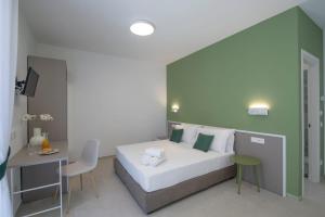 a bedroom with a large bed with a green wall at Rossy Palace - Amalficoast Suites in Agerola