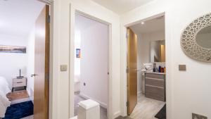 a white bathroom with a mirror and a bedroom at Mega7 Luxury 2bedrooms Apartment - 2baths, 3toilets plus Balcony and Free Car park in Manchester +50 photos