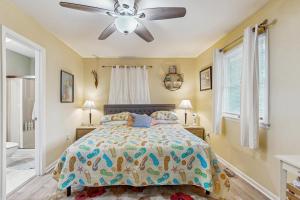 a bedroom with a bed and a ceiling fan at Beach Retreat in Ocean City