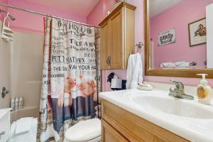 a bathroom with a sink and a shower curtain at Beach Retreat in Ocean City +18 photos