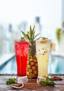 three cocktails sitting on a table with a pineapple at Hotel Zi One Luxury in Cartagena de Indias +93 photos