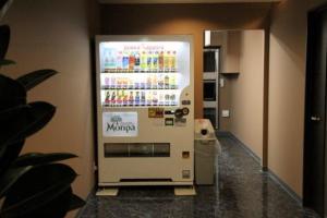 a vending machine with drinks on the side of a room at Condominium Hotel Monpa in Chatan