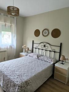 a bedroom with a bed and two tables and a window at Casa las granxias in El Escobal +34 photos