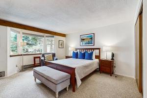 a bedroom with a bed with blue pillows at Sun Valley Serenity in Sun Valley +83 photos