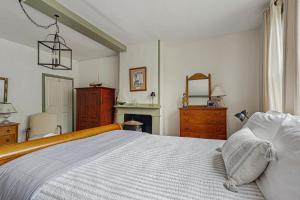 a bedroom with a large bed and a fireplace at Sunrise on the Sheepscot in Wiscasset