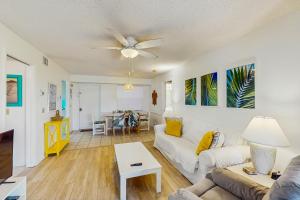 a living room with a couch and a ceiling fan at Sea Wood Coastal Hide Away in Edgewater