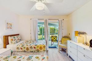 a bedroom with two beds and a dresser and a bedroom with a window at Sea Wood Coastal Hide Away in Edgewater +24 photos