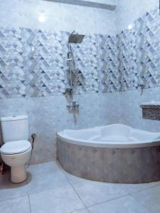 y baño con bañera y aseo. en Crystal Palace, en Luxor