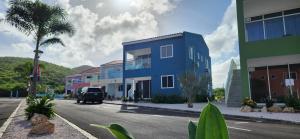 a blue building on the side of a street at Punta Azul in Westpunt +6 photos
