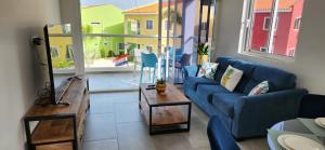 a living room with a blue couch and a table at Punta Azul in Westpunt