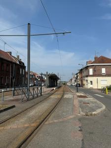 an empty street with train tracks in a town at Townhouse 4 bedrooms 4 double beds in Anzin