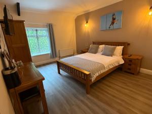 a bedroom with a large bed and a window at The Cottage Inn in Llandeilo
