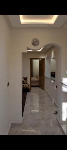 a living room with a hallway with a ceiling at diki ksar sghir in Oulad Akkou