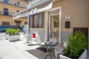 a patio with tables and chairs outside of a building at Rossy Palace - Amalficoast Suites in Agerola