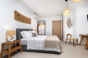 a bedroom with a bed and a table and chairs at Kefalas Luxury Villas Kelari Accessible Stone Studio in Epáno Kefalás