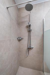 a bathroom with a shower with a glass door at Kefalas Luxury Villas Kelari Accessible Stone Studio in Epáno Kefalás +30 photos