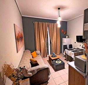 a living room with a couch and a table at Summer House Rocinante 1 in Vromerí